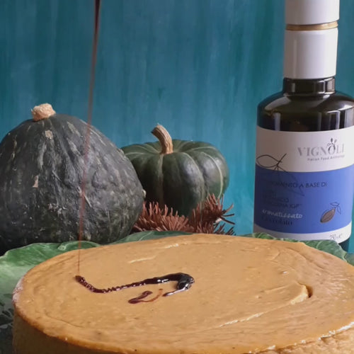 Chocolate Infused Balsamic Vinegar front of 8.5oz bottle pouring over pumpkin cheesecake