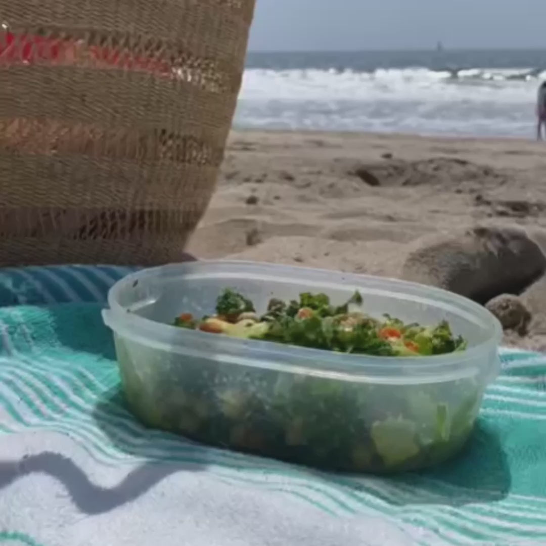 Apple Infused Balsamic Vinegar pouring over salad on the beach