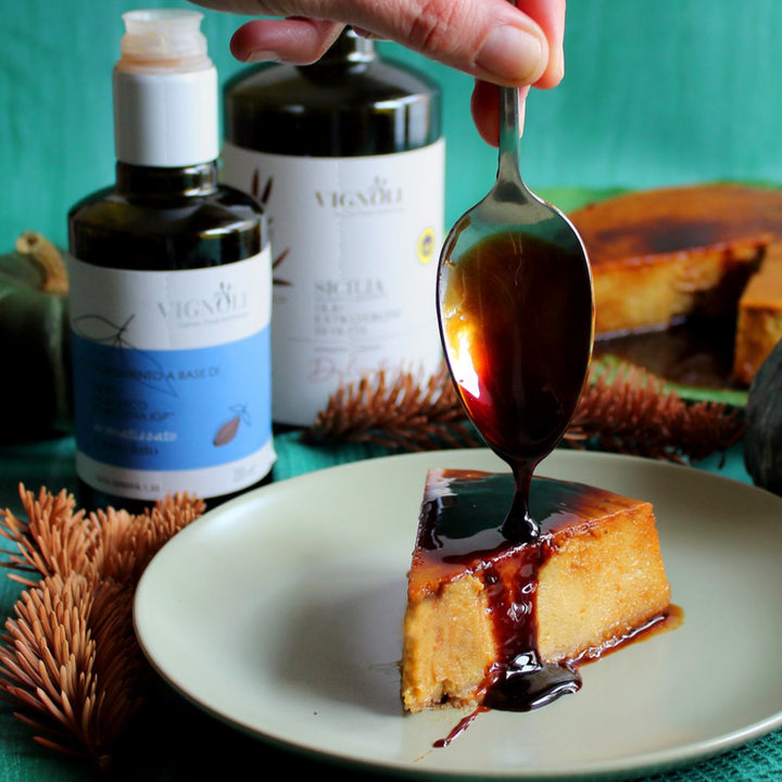 Chocolate Infused Balsamic Vinegar front of 8.5oz bottle pouring over cheesecake
