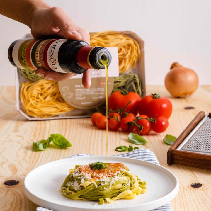 Extra Virgin Olive Oil - Everyday Kitchen front of 16.9oz bottle pouring over pasta