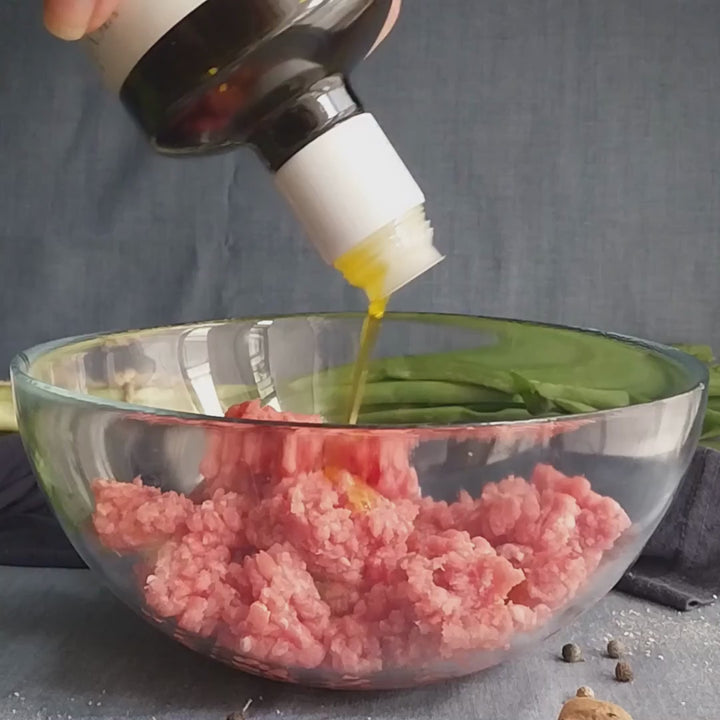 Vignoli Extra Virgin Olive Oil IGP Toscana - Medium front of 16.9oz bottle being poured over meatballs