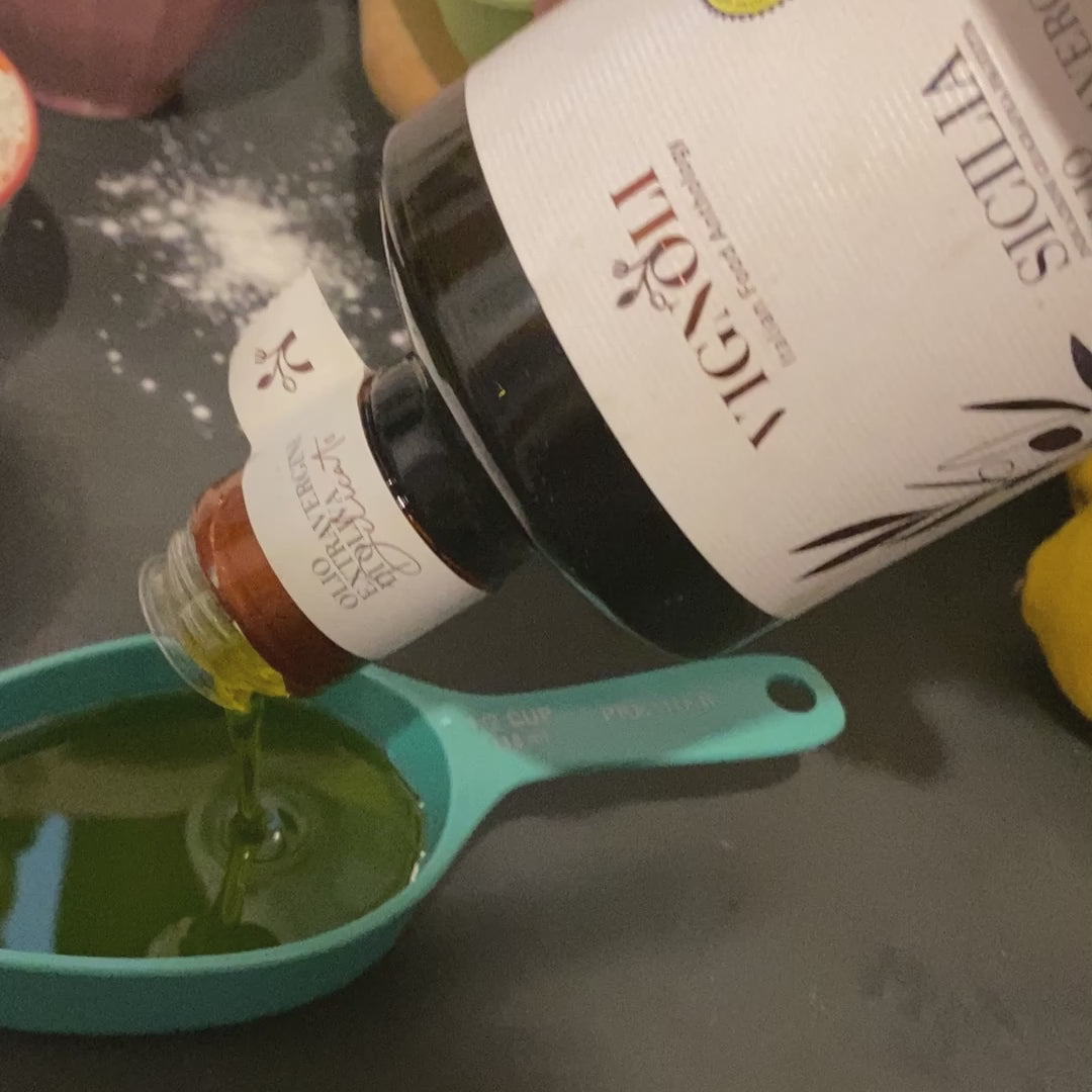 Vignoli Extra Virgin Olive Oil IGP Sicilia - Delicate front of 16.9oz bottle being poured into measuring spoon