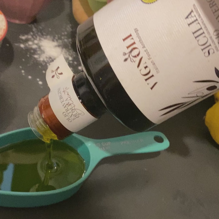Vignoli Extra Virgin Olive Oil IGP Sicilia - Delicate front of 16.9oz bottle being poured into measuring spoon