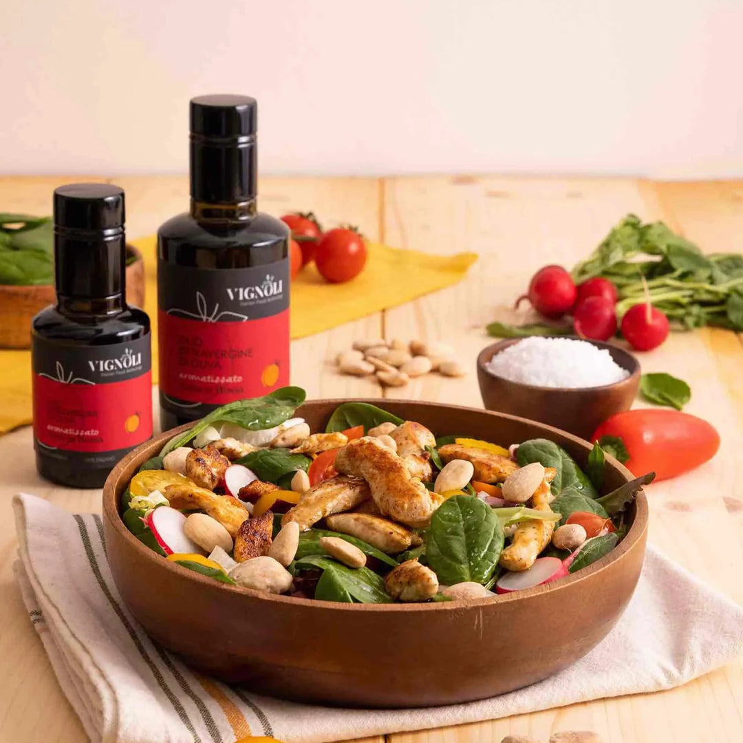 Blood Orange Infused Extra Virgin Olive Oil front of 8.5oz bottle on table with chicken salad