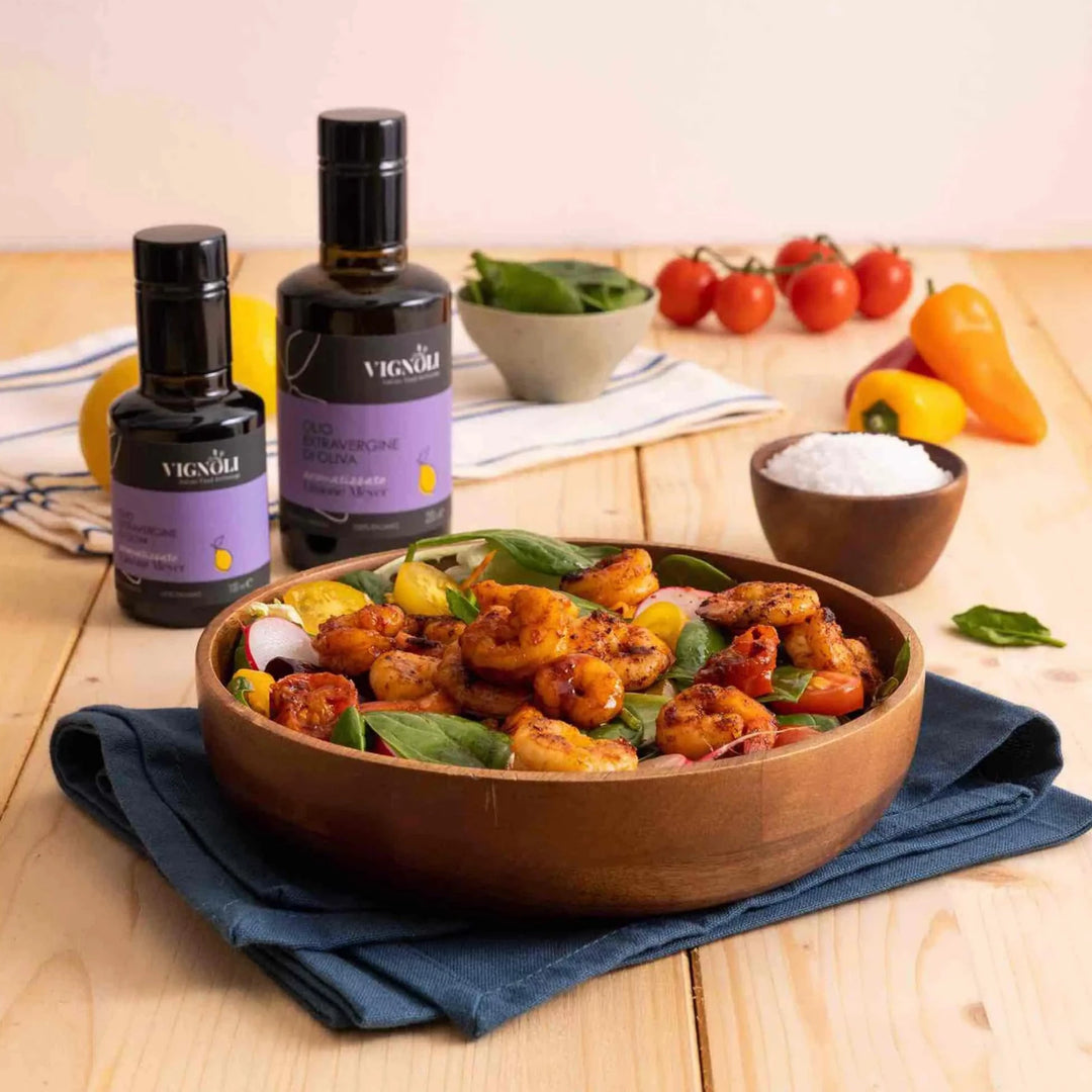 Vignoli Meyer Lemon Infused Extra Virgin Olive Oil front of 8.5oz bottle on kitchen table with shrimp salad in a wooden bowl